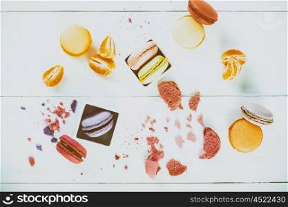 French Macaroons With Tangerine Slices On Wood Table