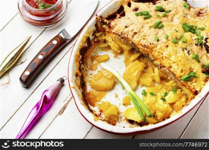 French meat is a dish made from layers of meat, potatoes and cheese.. Baked meat with potatoes and cheese.