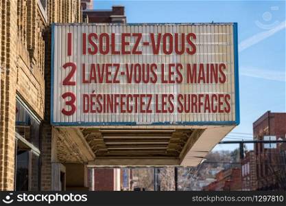 French movie cinema billboard with three rules to avoid the coronavirus epidemic. Translation, wash hands, maintain social distance and clean surfaces. Recommendations for avoiding Coronavirus on cinema board in French language