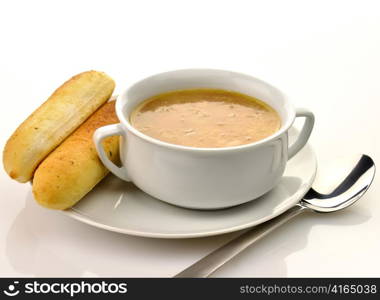 French Onion Soup in a white bowl with bread sticks