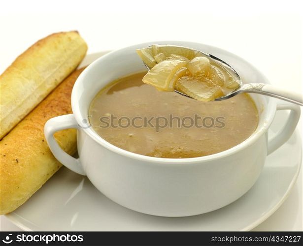 French Onion Soup in a white bowl with bread sticks