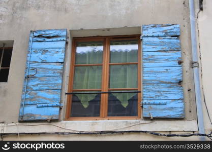 French style window with painted wooden shutters