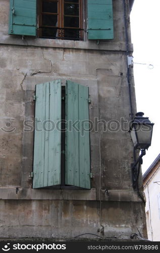 French style window with painted wooden shutters