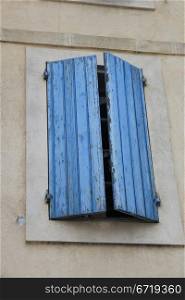 French style window with painted wooden shutters
