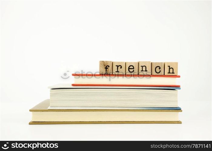 french word on wood stamps stack on books, conversation and translation concept