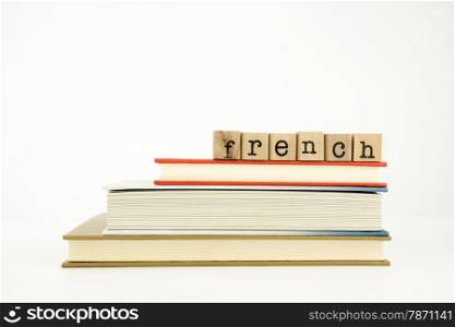 french word on wood stamps stack on books, conversation and translation concept