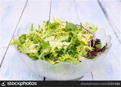 Fresch lettuce on a blue kitchen table.