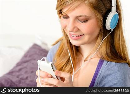 Fresh adolescent girl listening to music with mp3 player