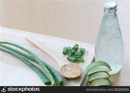 Fresh aloe vera and jelly in Glass bottle placed on a wooden flo. Fresh aloe vera and jelly in Glass bottle placed on a wooden floor and have copy space to input for design in your work.