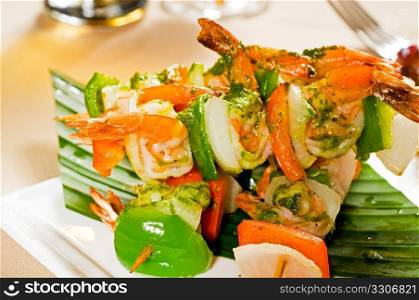fresh and colorfull grilled shrimps and vegetables skewers on a palm leaf ,thai style