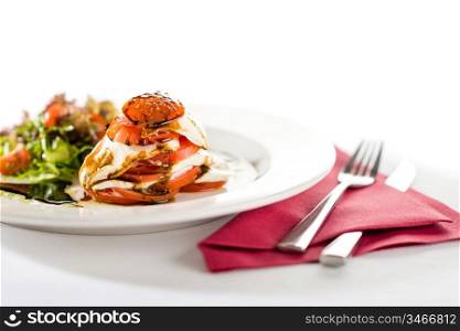 Fresh and delicious Caprese salad with tomatoes isolated on white