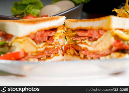 fresh and delicious classic club sandwich over a transparent glass dish