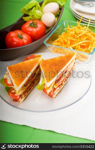 fresh and delicious classic club sandwich over a transparent glass dish