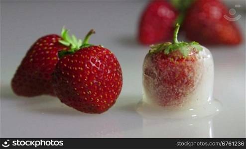 Fresh and frozen strawberry closeup time-lapse