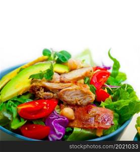 fresh and healthy Chicken Avocado salad over rustic wood table