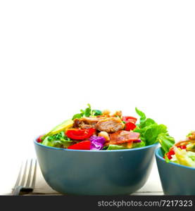 fresh and healthy Chicken Avocado salad over rustic wood table