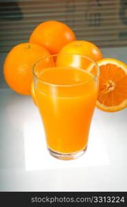 fresh and healthy orange juice ,unfiltered ,over a light table