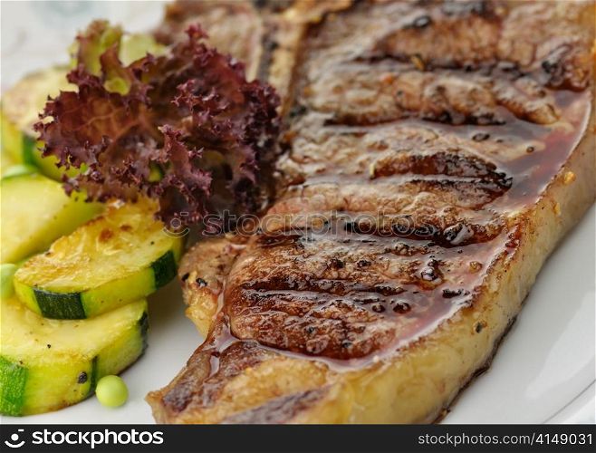 fresh and juicy t-bone steak with vegetables