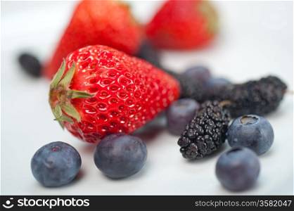 fresh and ripe strawberry mulberry and mulberry on white