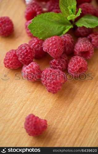 Fresh and sweet raspberries. Fresh and sweet raspberries on wooden background