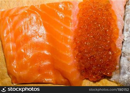 Fresh and tasty raw salmon fish fillet close up background.