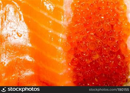 Fresh and tasty raw salmon fish fillet close up background.