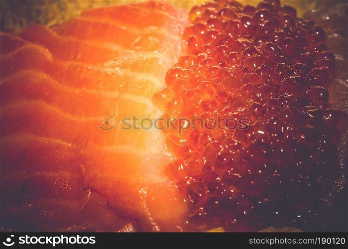 Fresh and tasty raw salmon fish fillet close up vintage background.