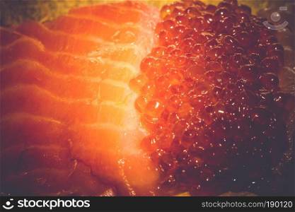 Fresh and tasty raw salmon fish fillet close up vintage background.