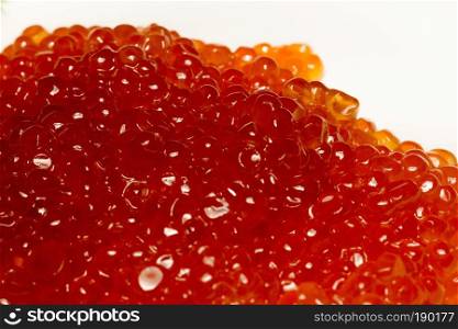 Fresh and tasty red salmon caviar close up background.