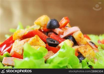Fresh and tasty salad on plate, golden background