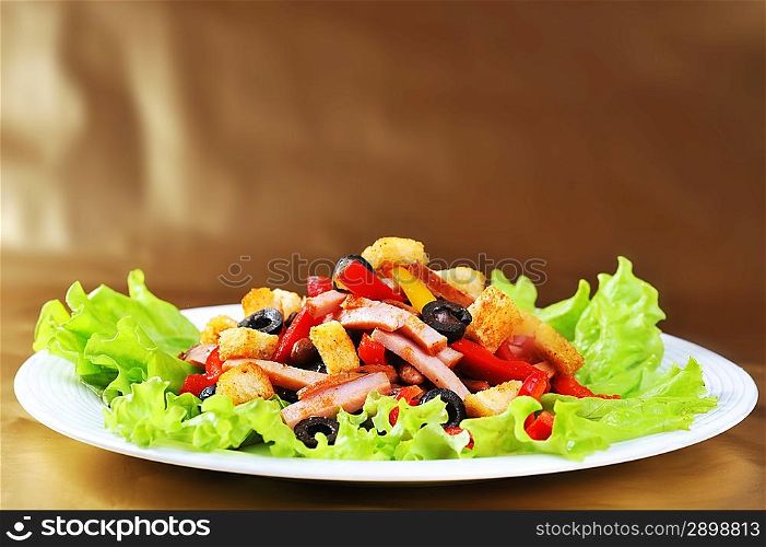 Fresh and tasty salad on plate, golden background