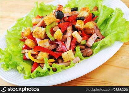 Fresh and tasty salad on plate, wooden table