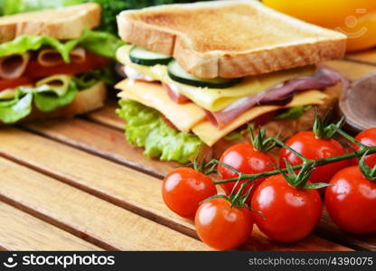 Fresh and tasty sandwich on wooden cutting board