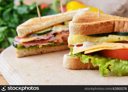 Fresh and tasty sandwich on wooden cutting board