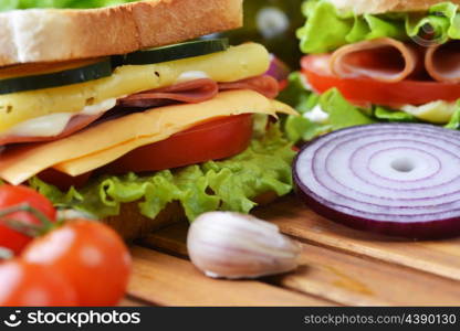 Fresh and tasty sandwich on wooden cutting board