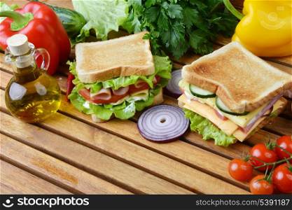 Fresh and tasty sandwich on wooden cutting board