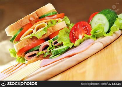 Fresh and tasty sandwich on wooden table