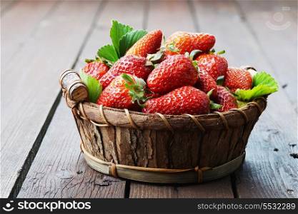 fresh and tasty strawberry in wicker basketfresh and tasty strawberry with green leaves