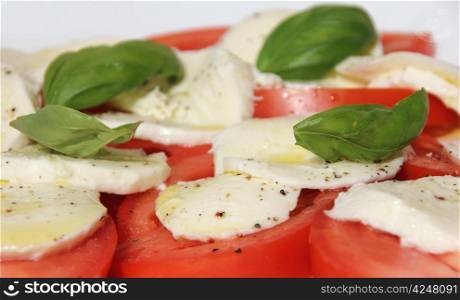 Fresh and tasty tomatoes, basil, mozzarella and olive oil