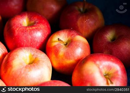 fresh apple - abstract natural background, half of the apples in the shot lay in the dark shadow