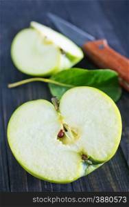 fresh apple and knife on wooden boards