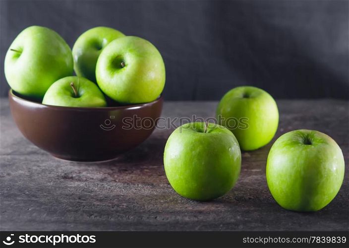 fresh apple. Bowl of green apples and apple over wooden board