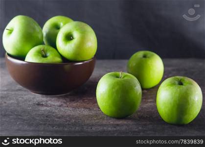 fresh apple. Bowl of green apples and apple over wooden board