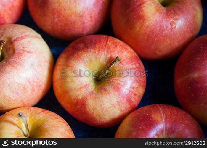 Fresh apple in market closeup background. Many fresh natural organic apples candid shot.