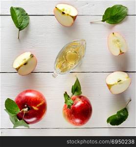 Fresh apples and vinegar on wooden table. Concept - healthy food from your garden. Top view.