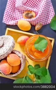 fresh apricot and jam in glass bank on a table