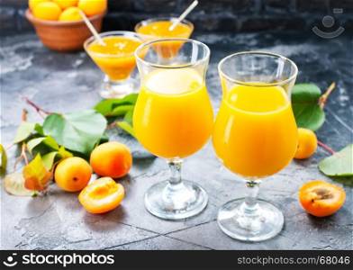 fresh apricot juice in glasses and on a table