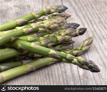 Fresh Asparagus Laid Out On A Rustic Kitchen Table