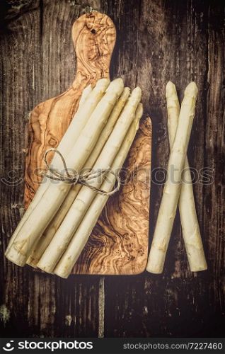Fresh asparagus on a wooden board in federal and wooden background