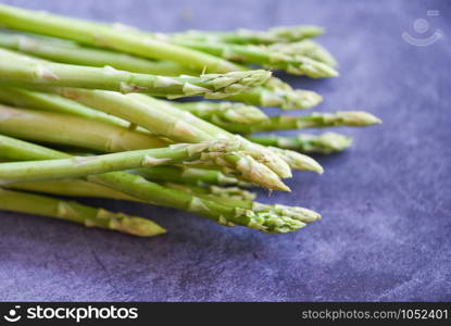 Fresh Asparagus on black background / Bunch green asparagus organic for cooking food